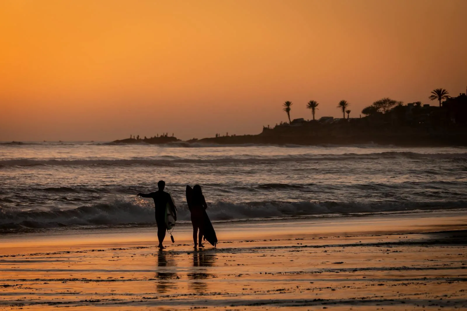 Surfeurs au coucher du soleil à Taghazout, le spot de surf le plus connu au nord d'Agadir